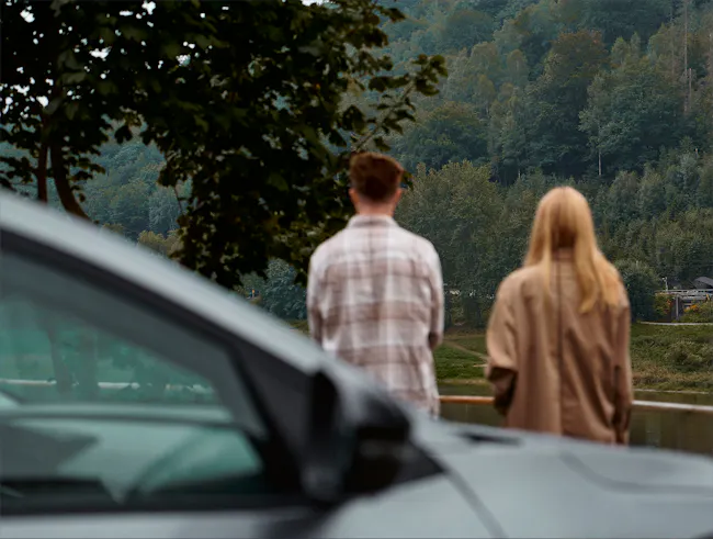 Couple behind a car