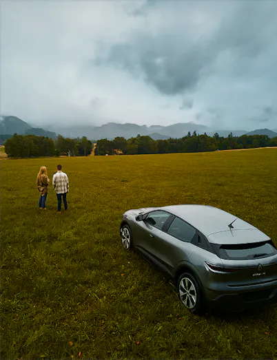 Car and a couple on a field