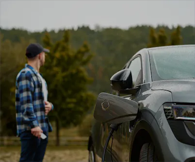 Man standing besides a car